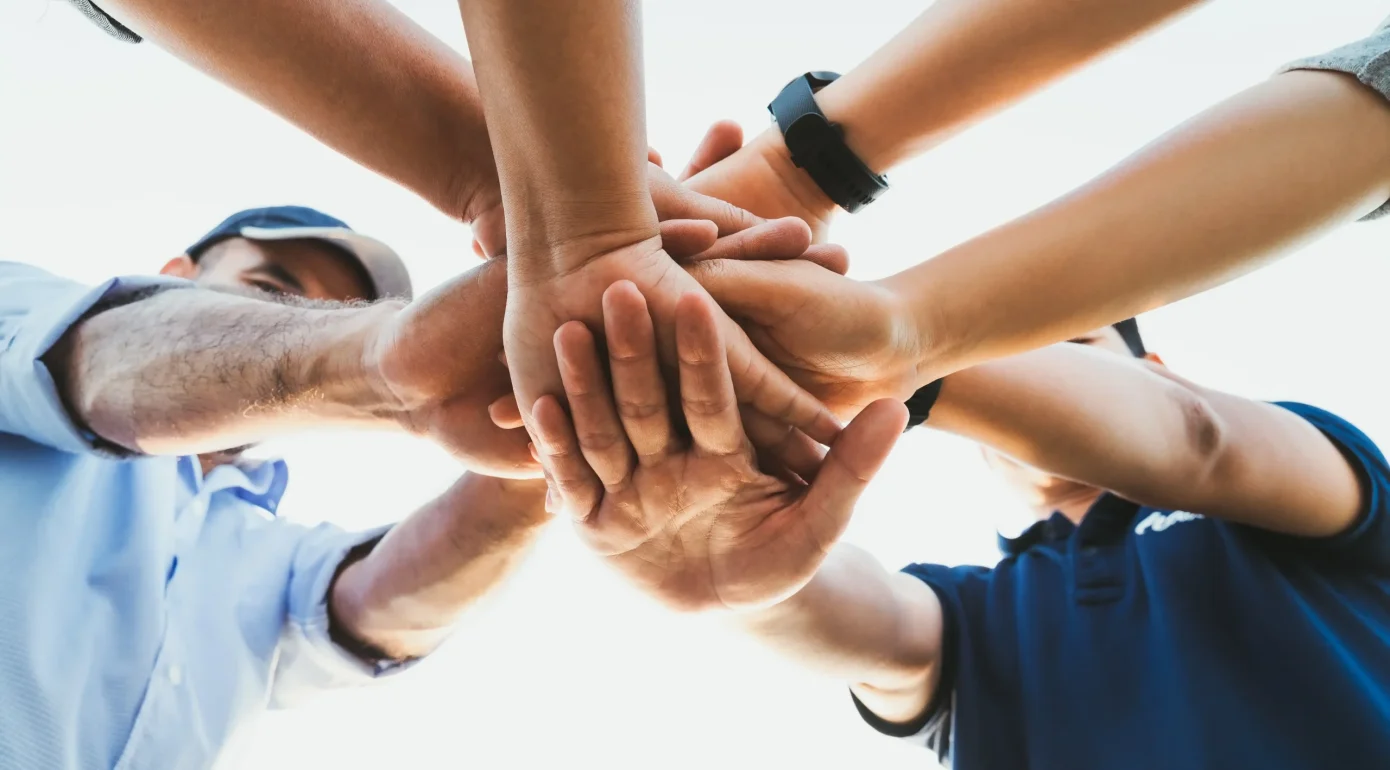 vecteezy_people-putting-their-hands-together-friends-with-stack-of_2910453_11zon_11zon